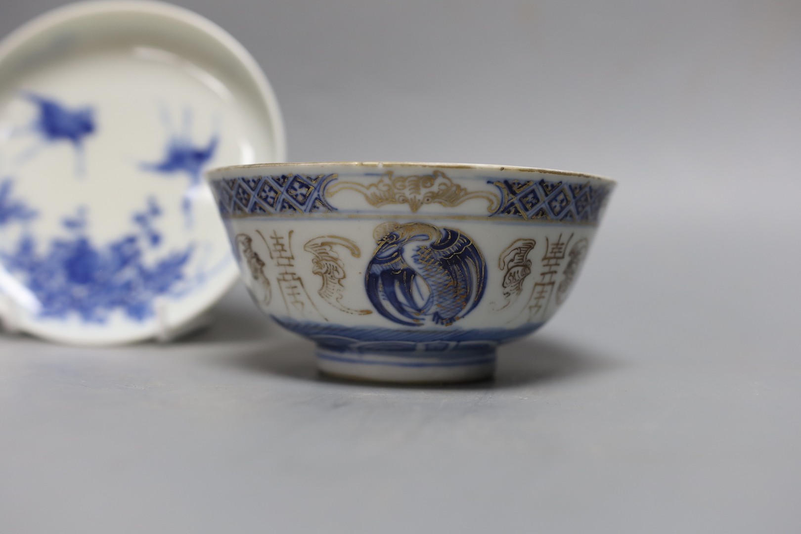 A Korean celadon bowl, a Chinese blue and white bowl, an iron red dish a famille Verte saucer and a Japanese blue and white saucer